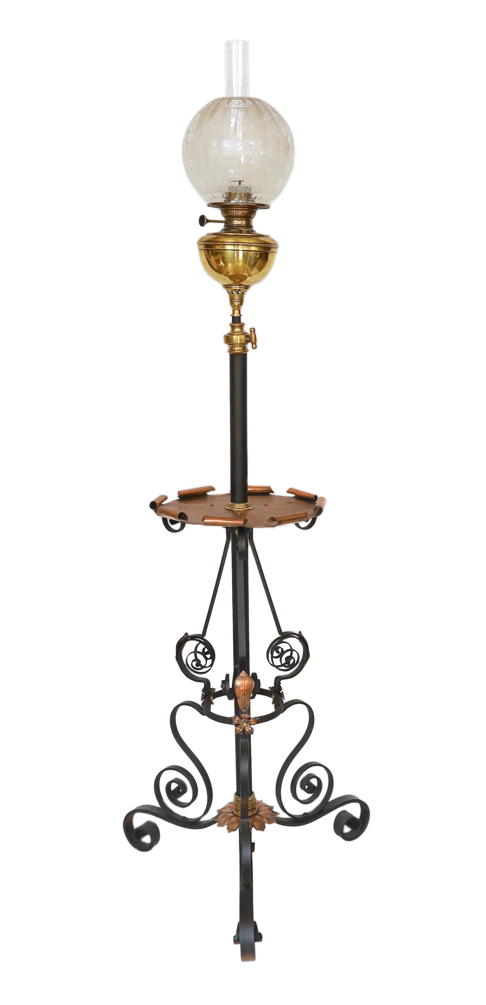 A late Victorian wrought iron brass and copper telescopic oil lamp standard with etched glass shade and flue, height overall 159cm